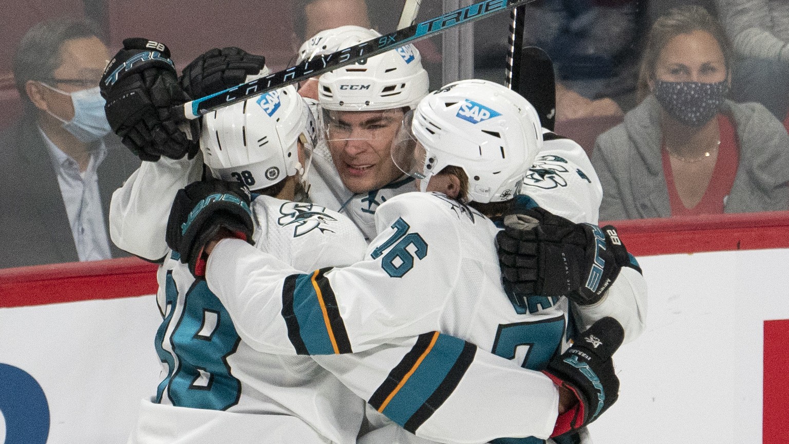 San Jose Sharks&#039; Jonathan Dahlen (76) celebrates with Mario Ferraro (38) and Timo Meier (28) after scoring a goal, as Montreal Canadiens&#039; Nick Suzuki (14) skates by during the first period o ...