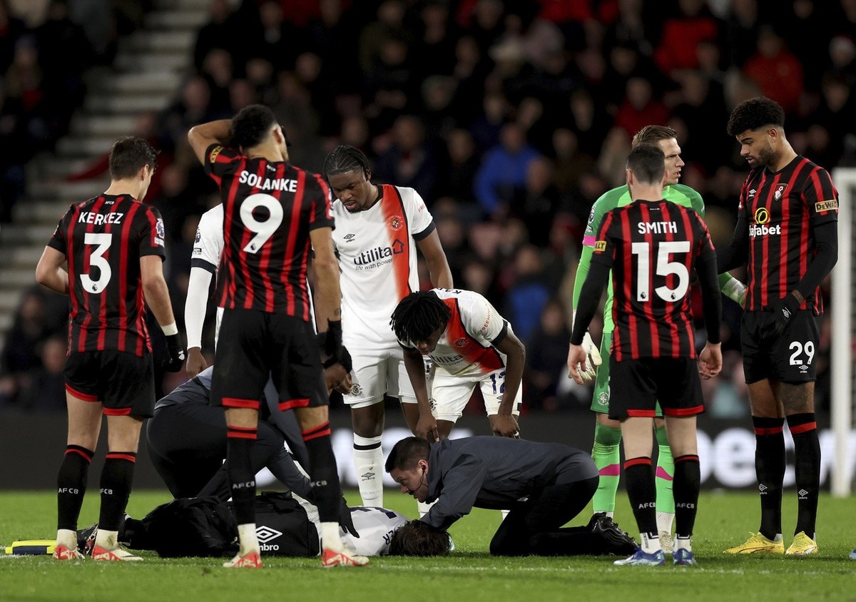 Luton Town's Tom Lockyer receives treatment on the pitch during the English Premier League soccer match between Bournemouth and Luton Town at the Vitality Stadium, in Bournemouth, England, Saturd ...