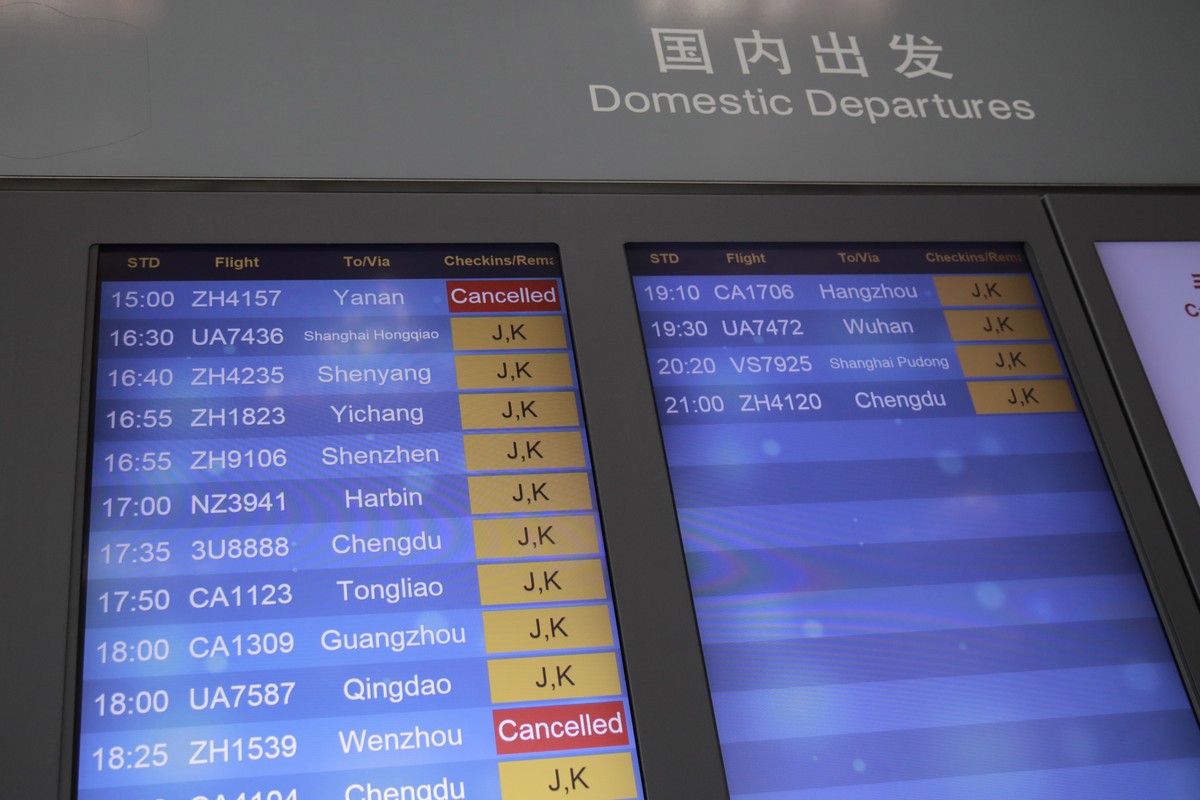 epa08490134 Flight information is displayed on a screen at terminal 3 of Beijing Capital International Airport in Beijing, China, 17 June 2020. Beijing cancelled over 1,200 flights amid new outbreak w ...