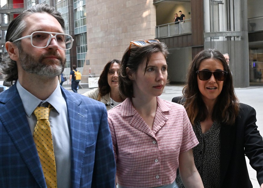 epa11390609 US citizen Amanda Knox (C), flanked by her husband Christopher Robinson (L), arrives at the courthouse in Florence, central Italy, 05 June 2024, before a hearing in a slander case related  ...