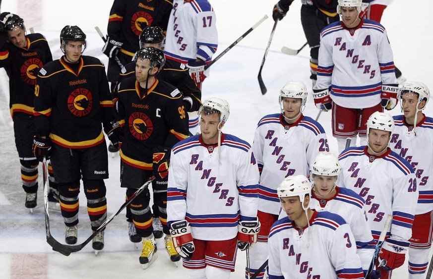 Bern players, left, and New York Rangers leave the stadium after an Ice Hockey exhibition game between SC Bern and New York Rangers, at the Postfinance Arena in Bern, Switzerland, Tuesday, September 3 ...