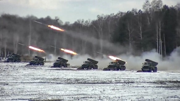 FILE - In this photo taken from video and released by the Russian Defense Ministry Press Service on Friday, Feb. 4, 2022, multiple rocket launchers fire during Belarusian and Russian joint military dr ...