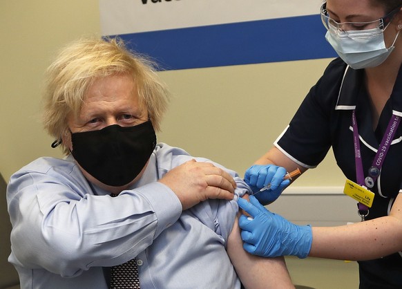 Britain's Prime Minister Boris Johnson receives the first dose of the AstraZeneca vaccine administered by nurse and Clinical Pod Lead, Lily Harrington at St.Thomas' Hospital in London, Friday, March 19, 2021. Johnson is one of several politicians across Europe, including French Prime Minister Jean Castex, getting a shot of the AstraZeneca vaccine on Friday. (AP Photo/Frank Augstein, Pool)