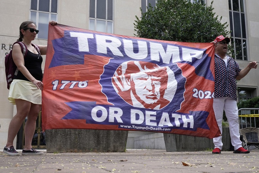 People protest at the E. Barrett Prettyman U.S. Federal Courthouse, Thursday, Aug. 3, 2023, in Washington. Former President Donald Trump is due in federal court in Washington today, to answer charges  ...