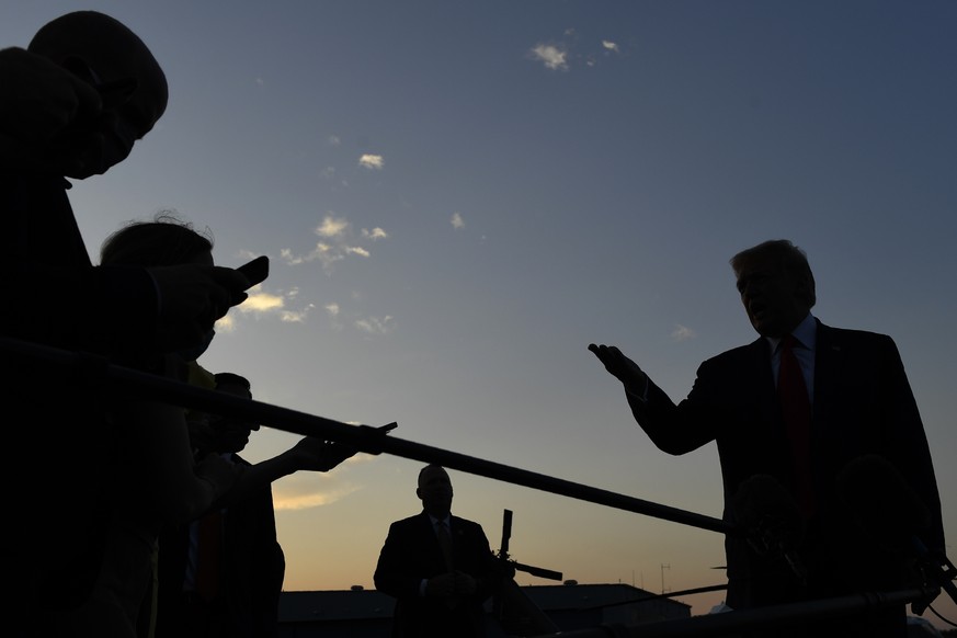 President Donald Trump talks with reporters before departing from Morristown Municipal Airport in Morristown, N.J., Sunday, Aug. 9, 2020. Trump was returning to Washington after spending the weekend a ...