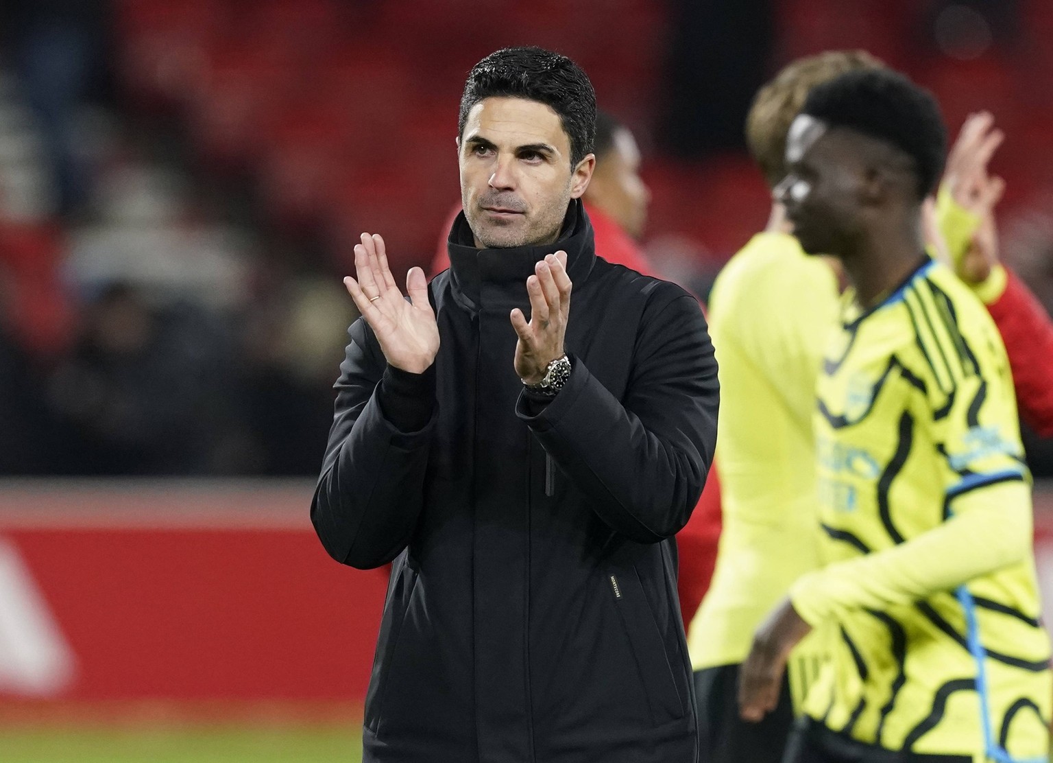 Nottingham, England, 30th January 2024. Mikel Arteta manager of Arsenal claps the fans at the final whistle during the Premier League match at the City Ground, Nottingham. Picture credit should read:  ...