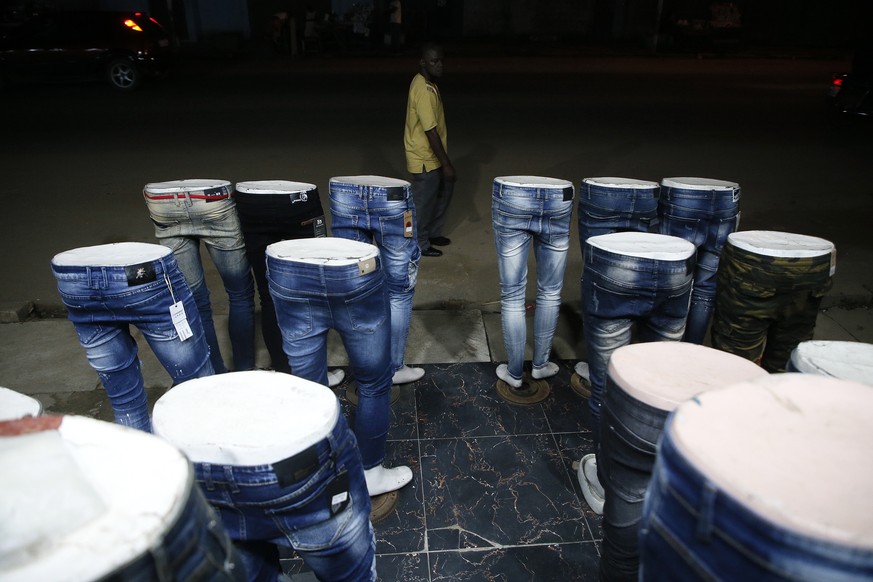 epa09299854 Jeans for sale on a street in Abidjan, Ivory Coast, 24 June 2021. Originally a small Ebrie tribe fishing village, Abidjan is now one of the most populous cities in Africa with over five mi ...