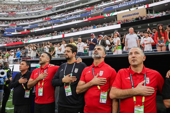 epa13040295 The coaching staff of the Islamic Republic of Iran during the national anthem prior to the FIFA World Cup 2026 group stage match Iran against New Zealand, in Los Angeles, California, USA,  ...