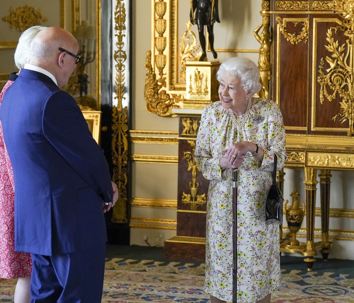 Britain's Queen Elizabeth II meets Pamela Harper and Dr Peter Harper from British craftwork company, Halcyon Days, to view a display of artefacts to commemorate the company's 70th anniversar ...