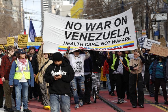 epa12624708 Demonstrators take part in a protest march to United Nations Plaza to voice opposition to US President Trump and the US military actions in Venezuela, in San Francisco, California, USA, 03 ...
