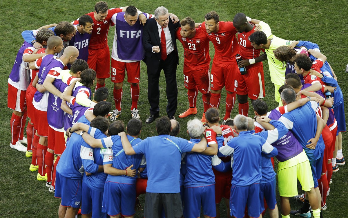 Switzerland's coach Ottmar Hitzfeld, top center, instructs his players during the break before the extra-time of the World Cup round of 16 soccer match between Argentina and Switzerland at the It ...