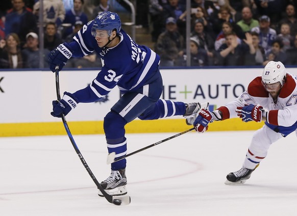 Feb 25, 2017; Toronto, Ontario, CAN; Toronto Maple Leafs forward Auston Matthews (34) shoots the puck as Montreal Canadiens forward Alex Galchenyuk (27) chases at the Air Canada Centre. Montreal defea ...