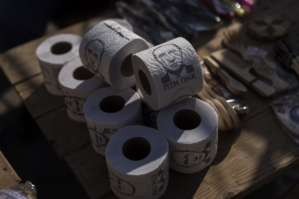 EDS NOTE: OBSCENE LANGUAGE - Toilet roll papers with pictures of Russian President Vladimir Putin and slur messages are for sale in a flea market in Lviv, western Ukraine, on Sunday, March 20, 2022. T ...