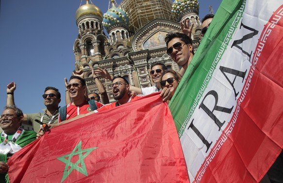 Iranian and Moroccan fans pose in font of the Saviour of Spilled Blood Cathedral during the 2018 soccer World Cup in St.Petersburg, Russia, Thursday, June 14, 2018. Iran will face Morocco in the 2018  ...