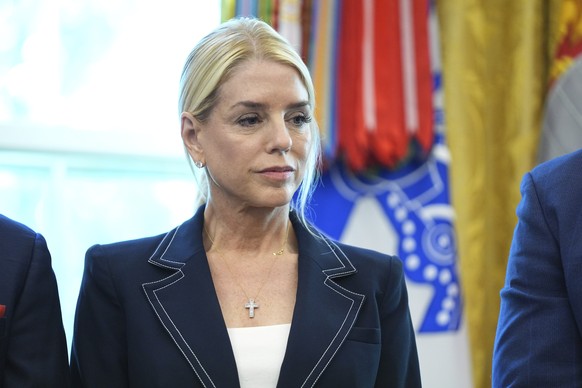 Attorney General Pam Bondi listens as President Donald Trump holds an executive order signing ceremony in the Oval Office of the White House, Monday, Aug. 25, 2025, in Washington. (AP Photo/Evan Vucci ...