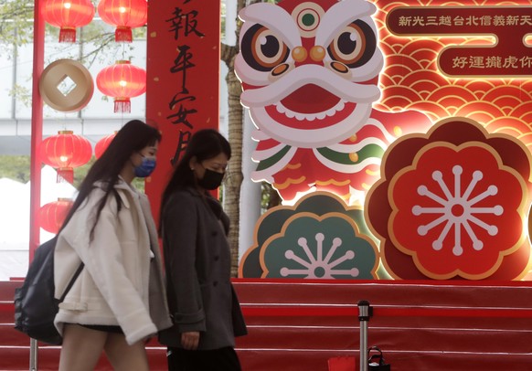 People walk past tiger decorations for the upcoming Chinese Lunar New Year, the year of the Tiger according to the Chinese zodiac, in Taipei, Taiwan, Friday, Jan. 28, 2022. The new year celebrations a ...