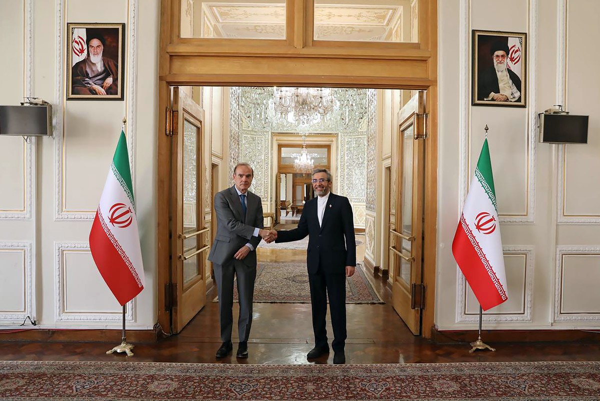 In this photo released by the Iranian Foreign Ministry, Enrique Mora, the European Union coordinator of talks to revive Iran's nuclear accord with world powers, left, shakes hands with Iran' ...