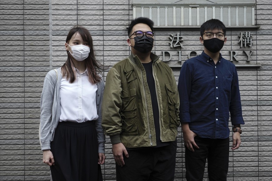 Hong Kong activists, from right, Joshua Wong, Ivan Lam and Agnes Chow arrive at a court in Hong Kong, Monday, Nov. 22. 2020. The trio appear at court for their trial as they face charges related to th ...