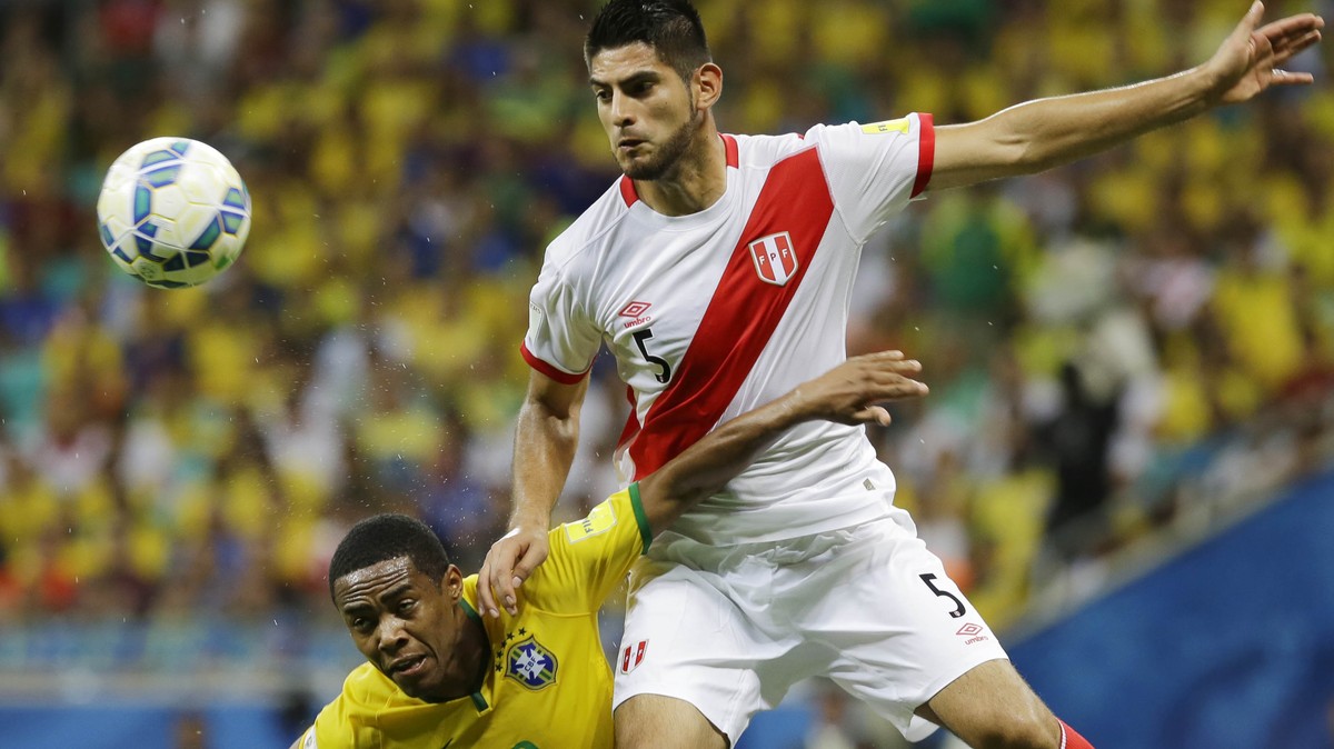 Brazil's Elias, left, fights for the ball with Peru's Carlos Zambrano during a 2018 World Cup qualifying soccer match in Salvador, Brazil, Tuesday, Nov. 17, 2015. (AP Photo/Nelson Antoine)