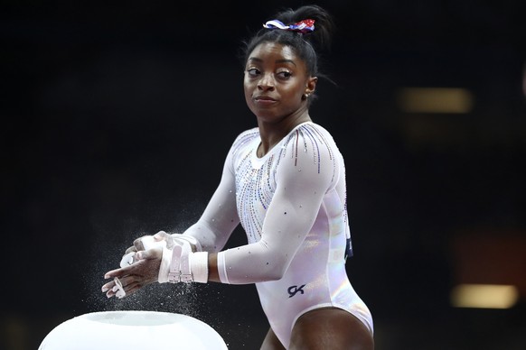FILE - In this Oct. 10, 2019, file photo, Simone Biles of the United States gets ready to perform on the uneven bars in the women's all-around final at the Gymnastics World Championships in Stuttgart, ...