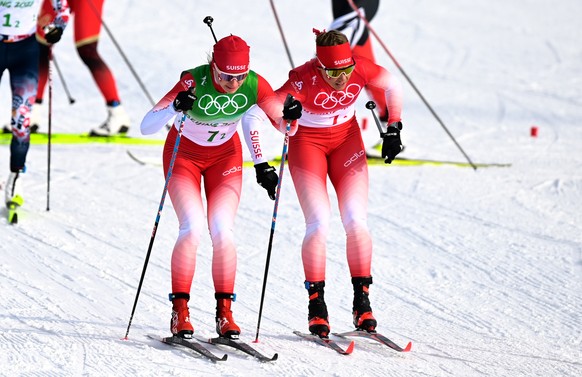 epa09748627 Nadine Faehndrich of Switzerland (L) takes over from Laurien van der Graaff of Switzerland (R) during the Women&#039;s 4x5km Relay race at the Zhangjiakou National Cross-Country Skiing Cen ...