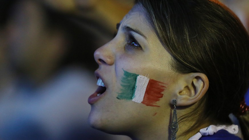 A Italian soccer fan watches a live broadcast of the World Cup match between England and Italy, inside the FIFA Fan Fest area on Copacabana beach, in Rio de Janeiro, Brazil, Saturday, June 14, 2014. I ...