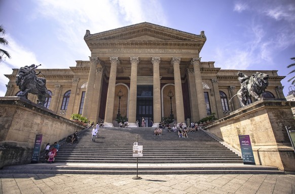 Tourists visiting the majestic teatro massimo vittorio emanuele in palermo, italy Palermo, Italy 1 January 2025: Tourists relaxing on the steps of teatro massimo vittorio emanuele in palermo, sicily,  ...