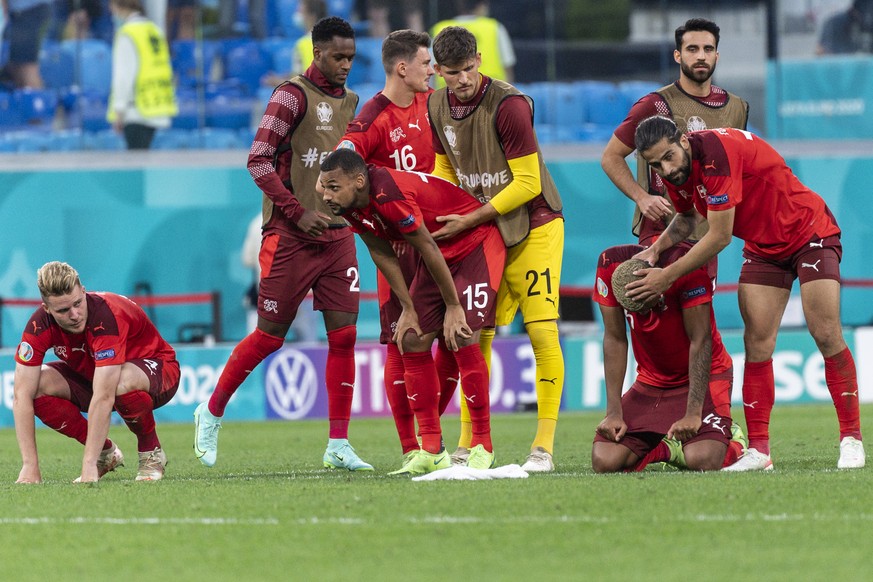 Switzerland&#039;s defender Ricardo Rodriguez, right, comforts defender Manuel Akanji, who just missed a penalty during the shootout session during the UEFA Euro 2020 soccer tournament quarterfinal so ...