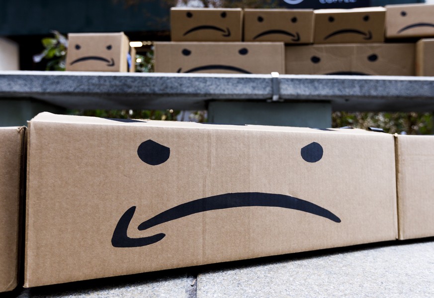 epa07200253 Boxes with a reimagined Amazon logo during a protest related to the recent announcement that the company Amazon will be opening one of two new headquarters in New York, New York, USA, 30 N ...