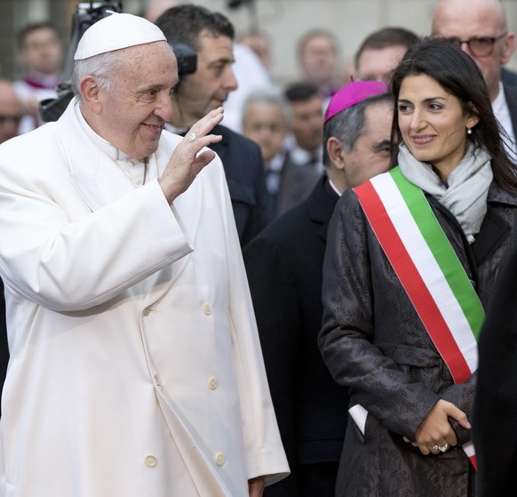 Pope Francis greets Rome&#039;s Mayor Virginia Raggi before praying in front of the statue of the Virgin Mary, near Rome’s Spanish Steps Friday, Dec. 8, 2017, an annual tradition marking the start of  ...