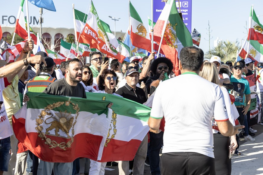epa13040275 Members of the Iranian diaspora wave flags during a protest outside Los Angeles Stadium ahead of the FIFA World Cup 2026 Group G soccer match between Iran and New Zealand in Inglewood, Cal ...