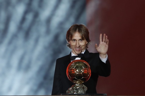 Real Madrid's Luka Modric celebrates with the Ballon d'Or award during the Golden Ball award ceremony at the Grand Palais in Paris, France, Monday, Dec. 3, 2018. Awarded every year by France ...