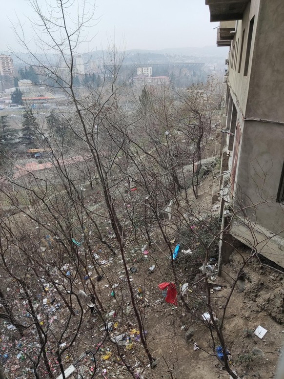 Garbage dump in front of a residential building