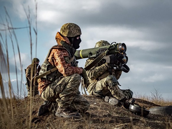 In this image released by Ukrainian Defense Ministry Press Service, Ukrainian soldiers use a launcher with US Javelin missiles during military exercises in Donetsk region, Ukraine, Thursday, Dec. 23,  ...