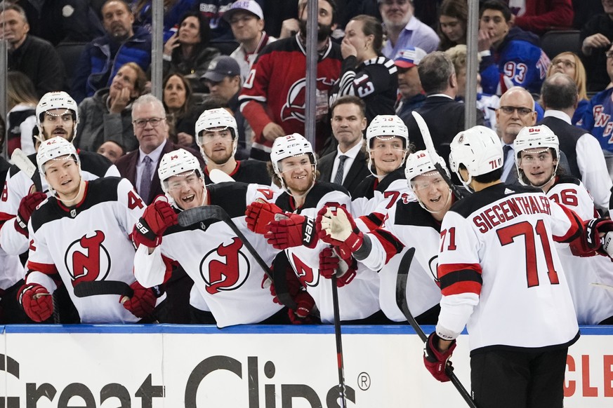 New Jersey Devils&#039; Jonas Siegenthaler (71) celebrates with teammates after scoring a goal during the third period of Game 4 of an NHL hockey Stanley Cup first-round playoff series against the New ...