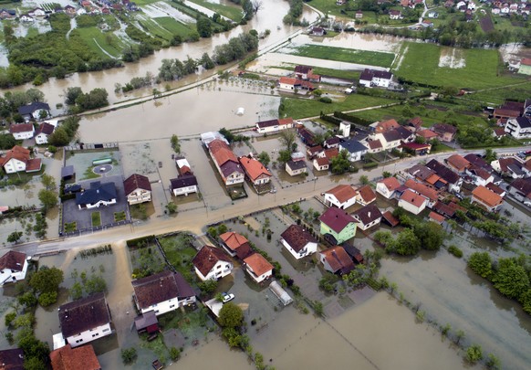 This aerial photo shows flooded neighborhood in Sanski Most, Bosnia-Herzegovina, Tuesday, May 14, 2019. Homes and roads have been flooded in parts of Bosnia after rivers broke their banks following he ...