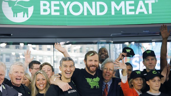 FILE - In this May 2, 2019, file photo Ethan Brown, center, CEO of Beyond Meat, attends the Opening Bell ceremony with guests to celebrate the company&#039;s IPO at Nasdaq in New York. Plant-based mea ...