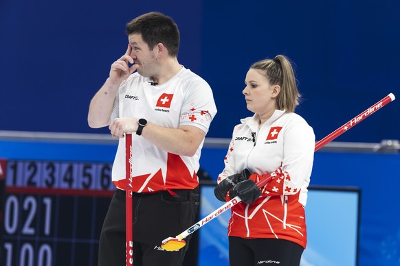 Martin Rios, left, and Jenny Perret of Switzerland team reacts during the curling mixed doubles preliminary round game between Czech Republic and Switzerland at the 2022 Olympic Winter Games in Beijin ...