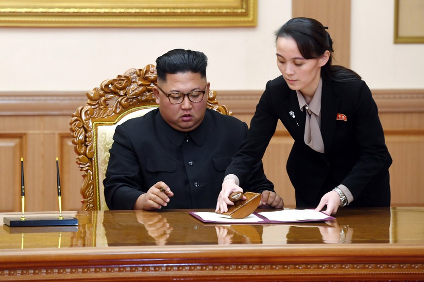 FILE - In this Sept. 19, 2018, file photo, Kim Yo Jong, right, helps her brother North Korean leader Kim Jong Un sign a joint statement following the summit with South Korean President Moon Jae-in at  ...