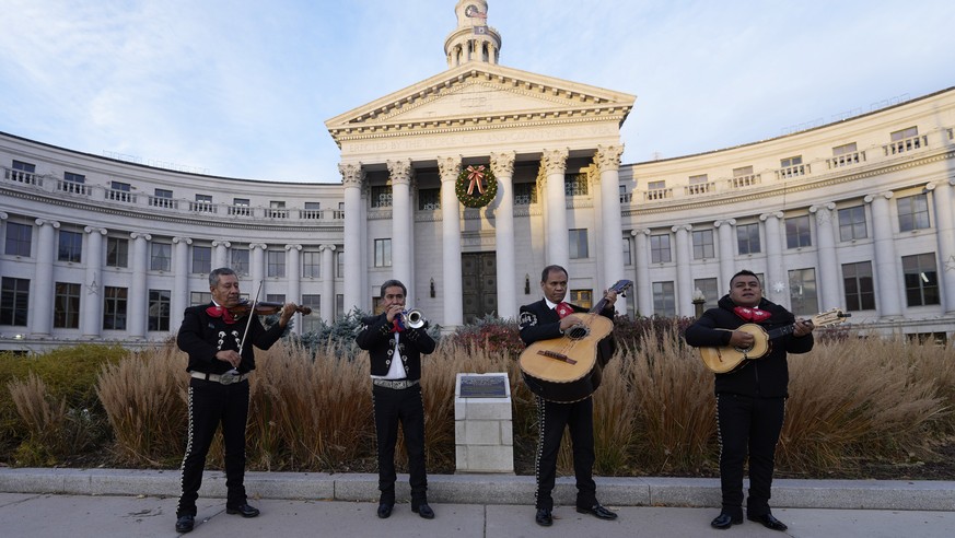 From left, members of Mariachi America Javier Medina, DeJesus Diaz, Miguel Valaquez and Cesar Abraham perform outside the C/ity/County Building for voters to open the polling places early Tuesday, Nov ...