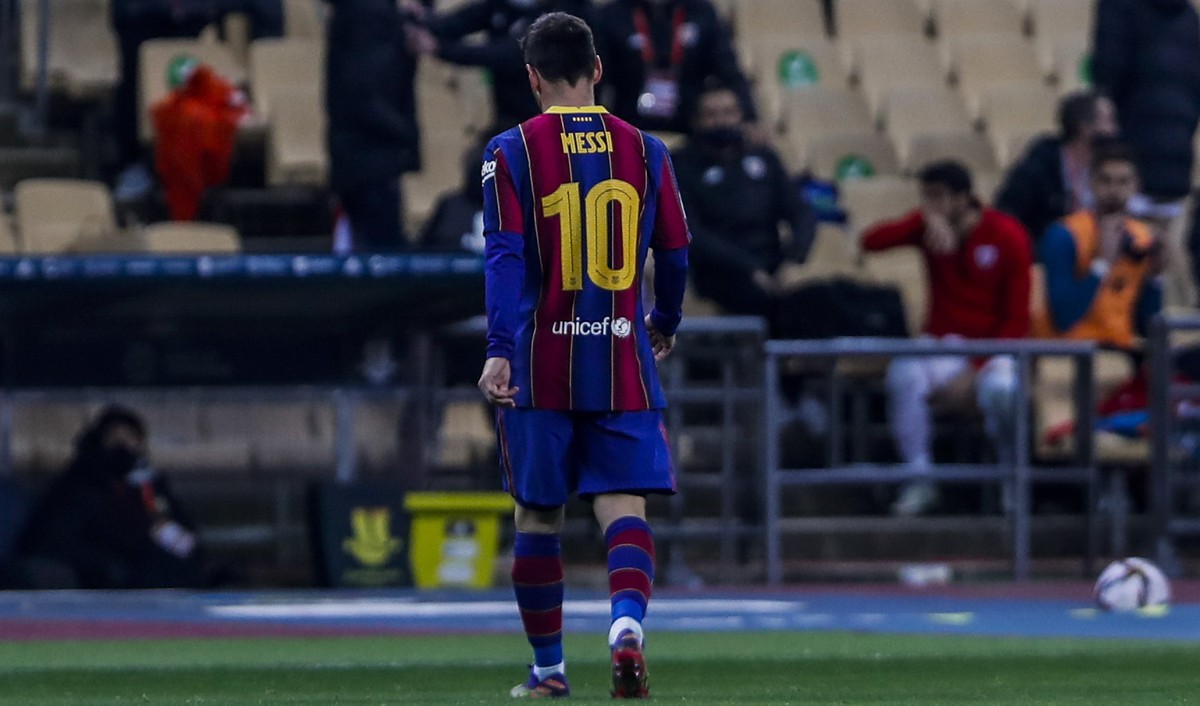 Barcelona's Lionel Messi walks out of the pitch after being shown a red card during the Spanish Supercopa final soccer match against FC Barcelona at La Cartuja stadium in Seville, Spain, Sunday,  ...