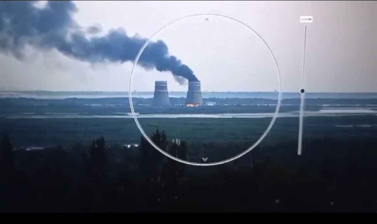 In this image from a surveillance camera provided by the Ukrainian Presidential Press Office, smoke rises from a cooling tower of the Zaporizhzhia Nuclear Power Station in a Russia-controlled area in  ...