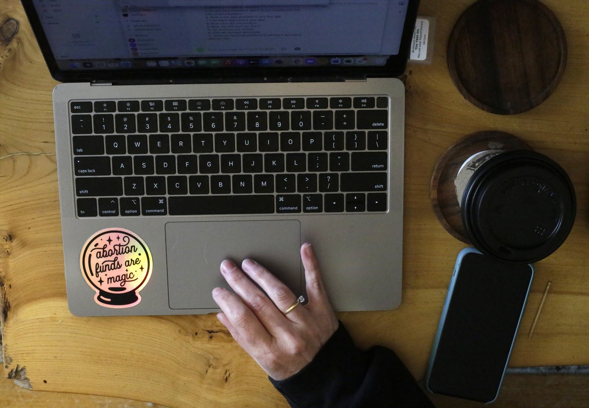 Alison Dreith works on her computer on Thursday, April 14, 2022, in her home in southern Illinois. Dreith works for the Midwest Access Coalition, which pays for "practical support" for women ...