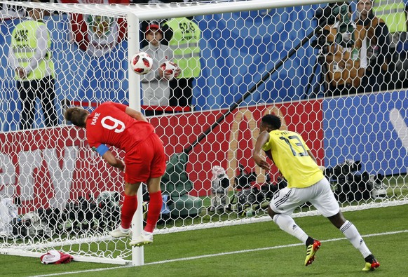 England&#039;s Harry Kane tries to score with a header next to Colombia&#039;s Yerry Mina, right, during the round of 16 match between Colombia and England at the 2018 soccer World Cup in the Spartak  ...