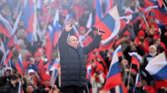 epa09833752 Russian President Vladimir Putin attends a concert marking the 8th anniversary of Crimea's reunification with Russia at the Luzhniki stadium in Moscow, Russia, 18 March 2022. Russia i ...