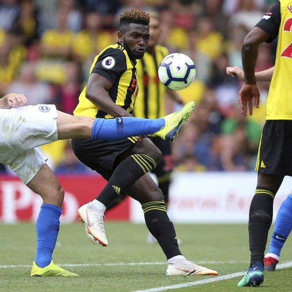 Brighton &amp; Hove Albion&#039;s Davy Propper, left, reaches for the ball with Watford&#039;s Isaac Success during their English Premier League soccer match at Vicarage Road in London, England, Satur ...