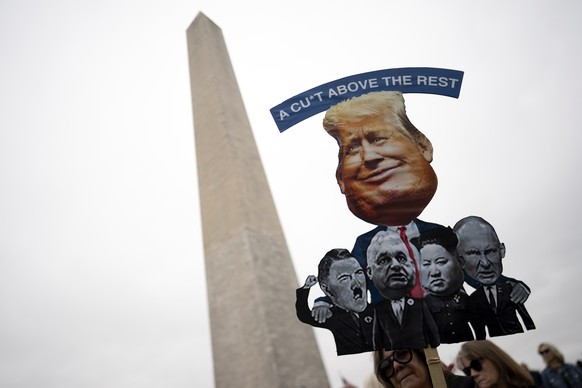 epa12012439 Protesters take part in a the nationwide 'Hands Off!' demonstration on the National Mall in Washington, DC, USA, 05 April 2025. Protesters have been called across the country in ...