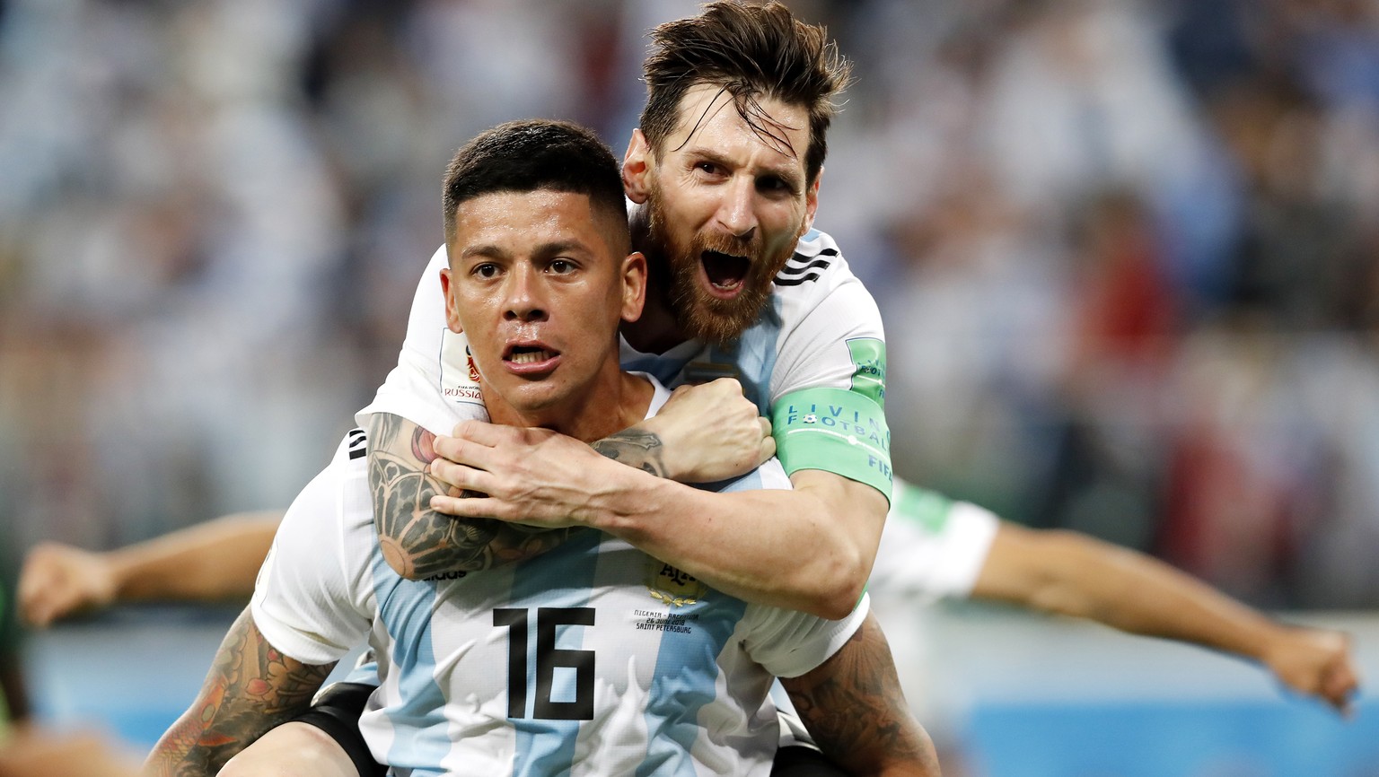 epa06842837 Marcos Rojo of Argentina celebrates with teammate Lionel Messi (top) after scoring the 2-1 during the FIFA World Cup 2018 group D preliminary round soccer match between Nigeria and Argenti ...