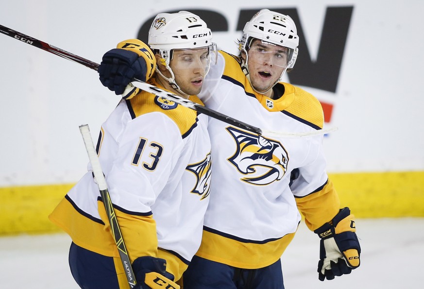 Nashville Predators&#039; Kevin Fiala, right, of Switzerland, celebrates his goal with teammate Nick Bonino during NHL hockey game action against the Calgary Flames in Calgary, Alberta, Friday, Oct. 1 ...