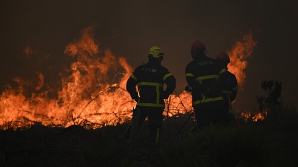 Firefighters spray water in a burning forest near Lacanau, southwestern France, Saturday, July 25, 2026. (AP Photo/Emma Da Silva)
France Wildfires